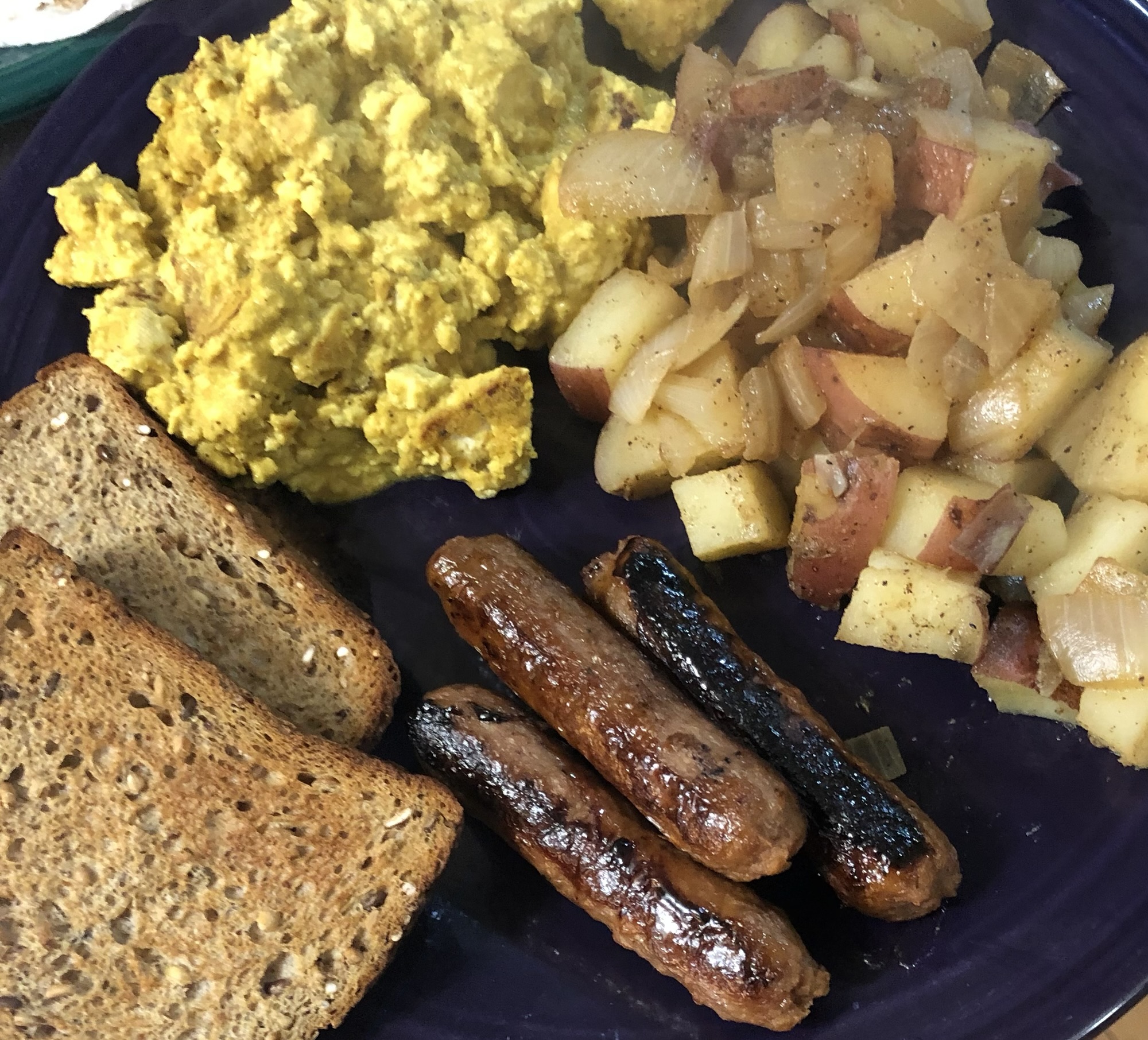tofu scramble, potatoes, veggie sausage links, and toast